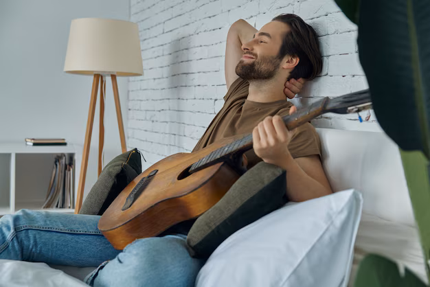 Person playing an acoustic guitar